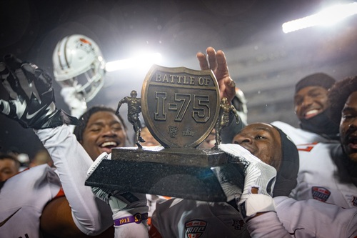 Football players holding up a trophy