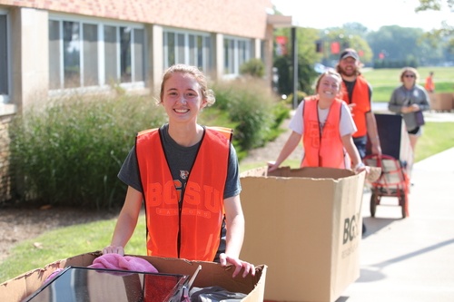Student volunteers outside residence hall during move-in