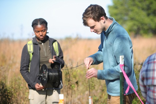 Two Environmental Science students performing outdoor field research