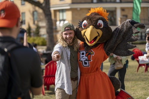 Frieda poses with student on campus lawn