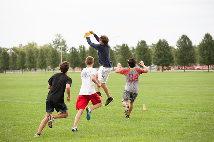 students playing frisbee on IM field