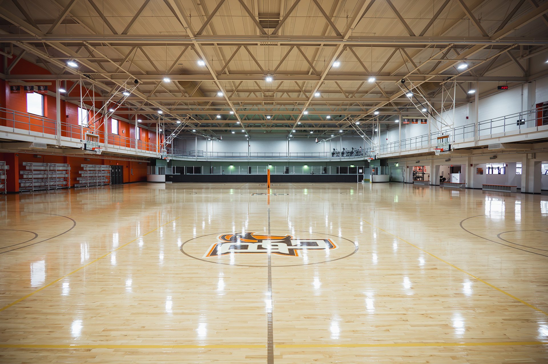 Indoor hardwood activity courts set up for basketball and volleyball