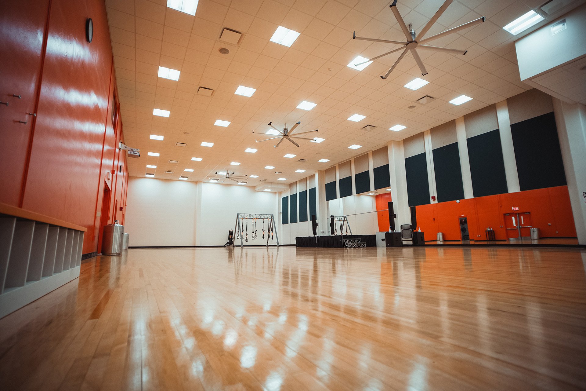 Studio B group fitness space with hardwood flooring and TRX equipment