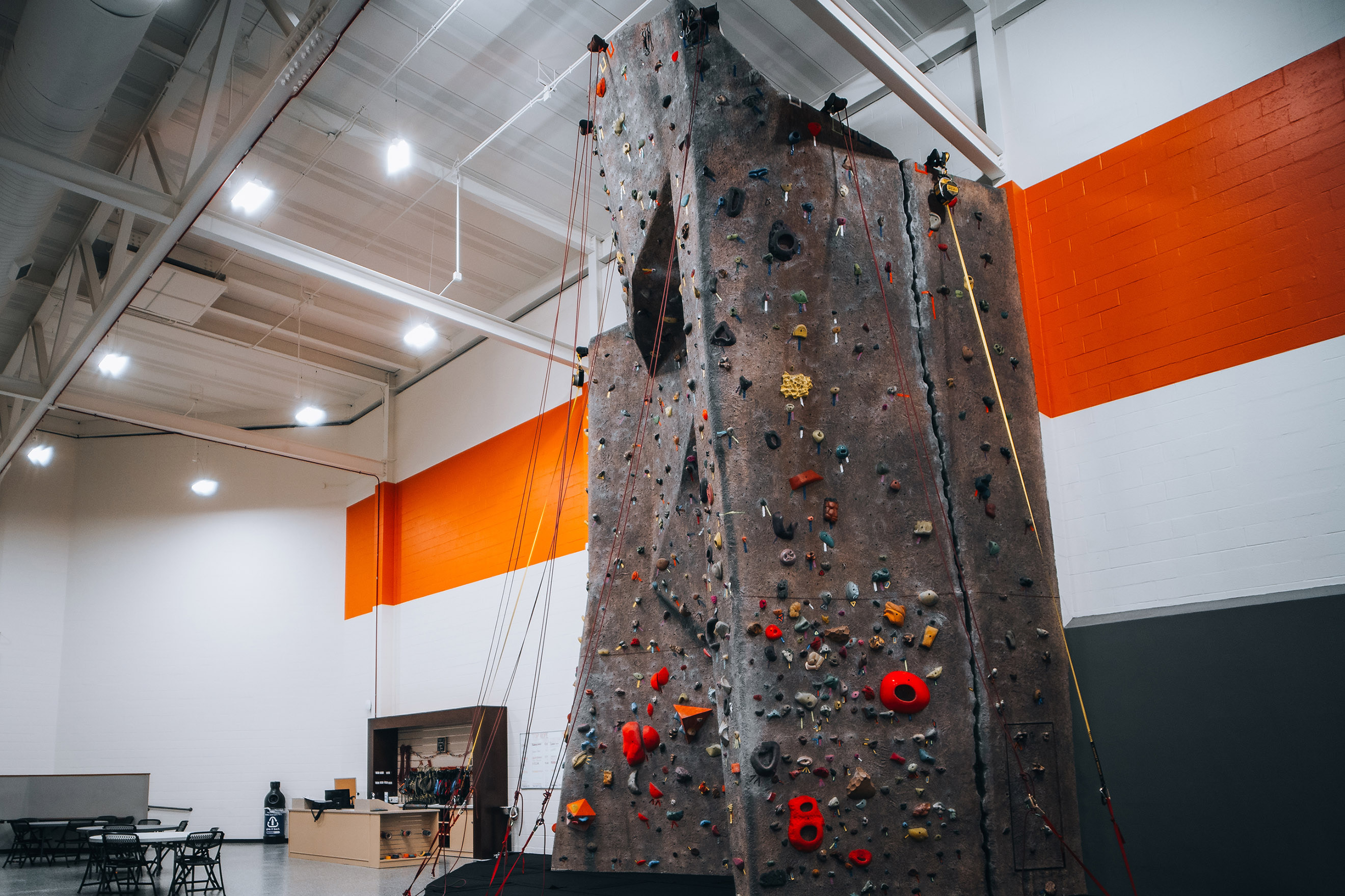 Tall indoor climbing wall with climbing holds