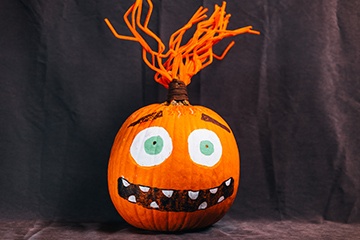 A pumpkin decorated as the character Anxiety from Inside Out. 