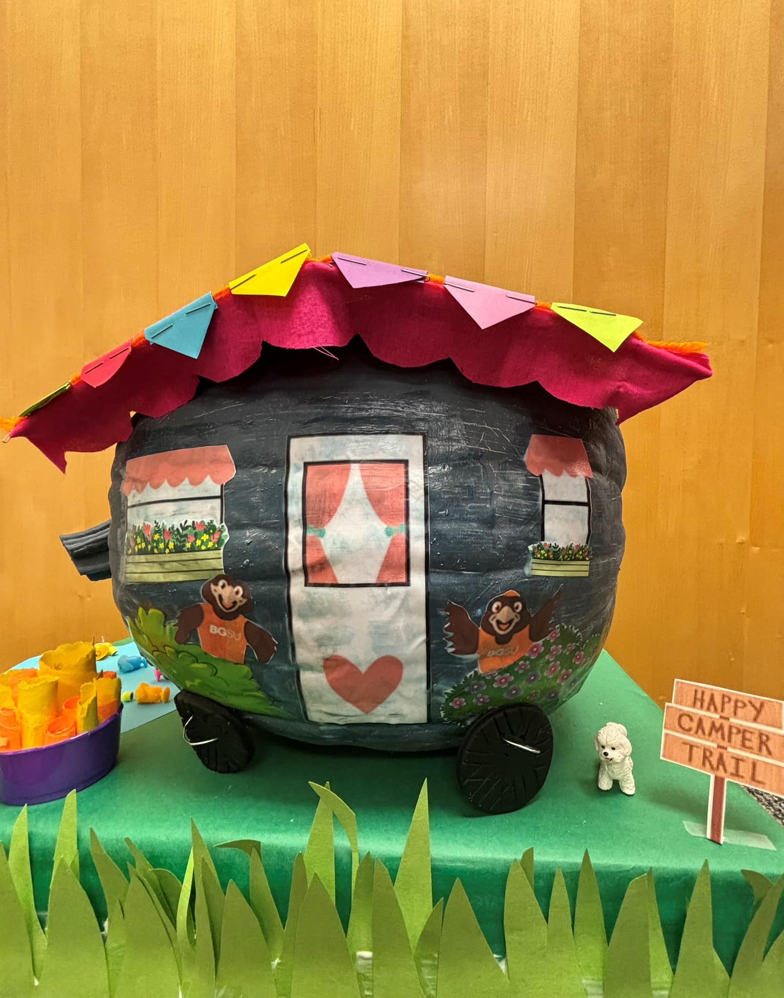 A pumpkin decorated as a camper. 