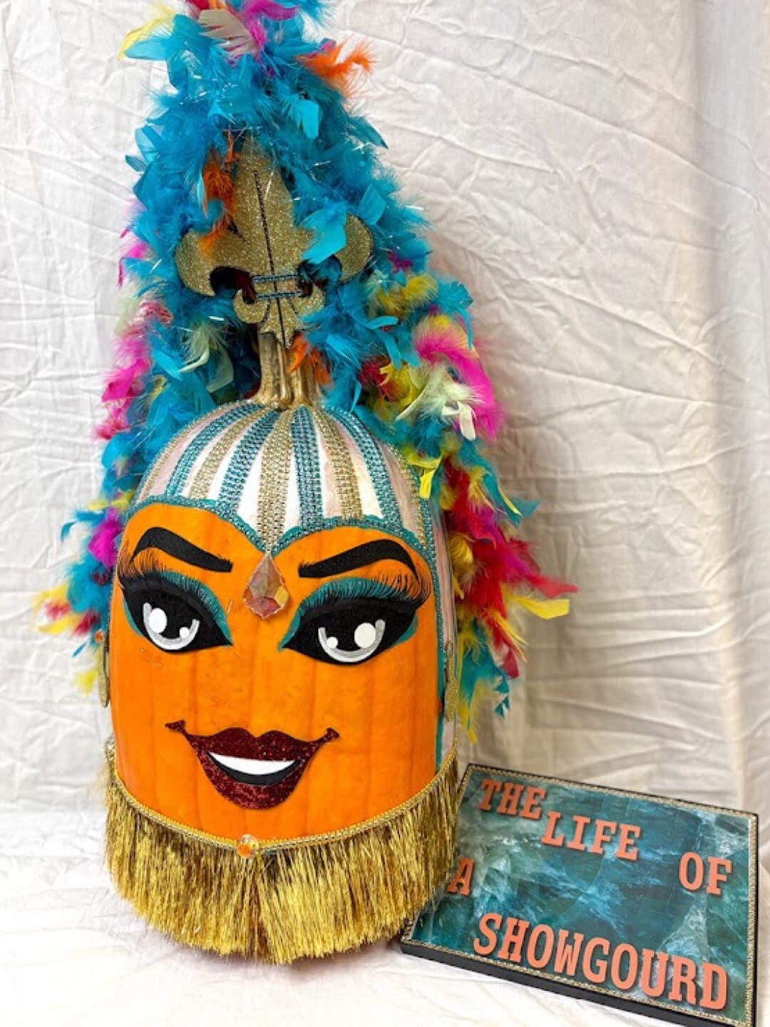 A pumpkin decorated as Taylor Swift. 