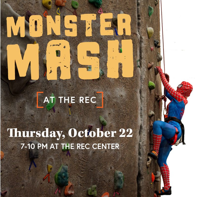Person in a Spider Man costume climbing the Rec Center climbing wall at a previous Monster Mash event. 