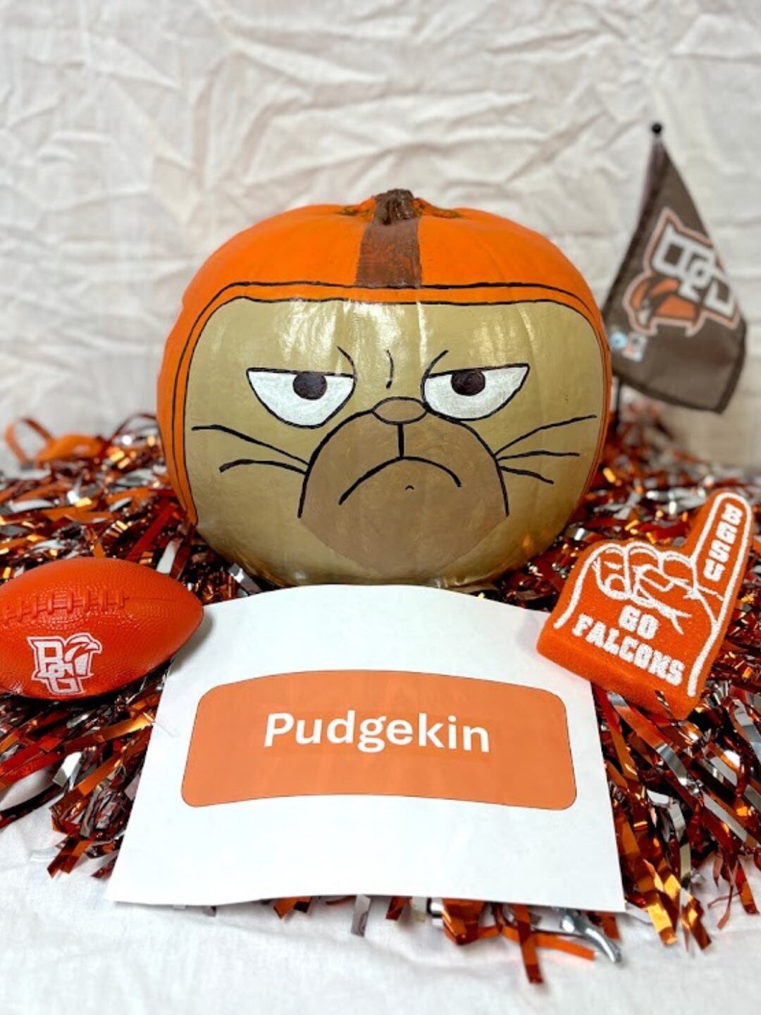A pumpkin decorated as Pudge the cat. 