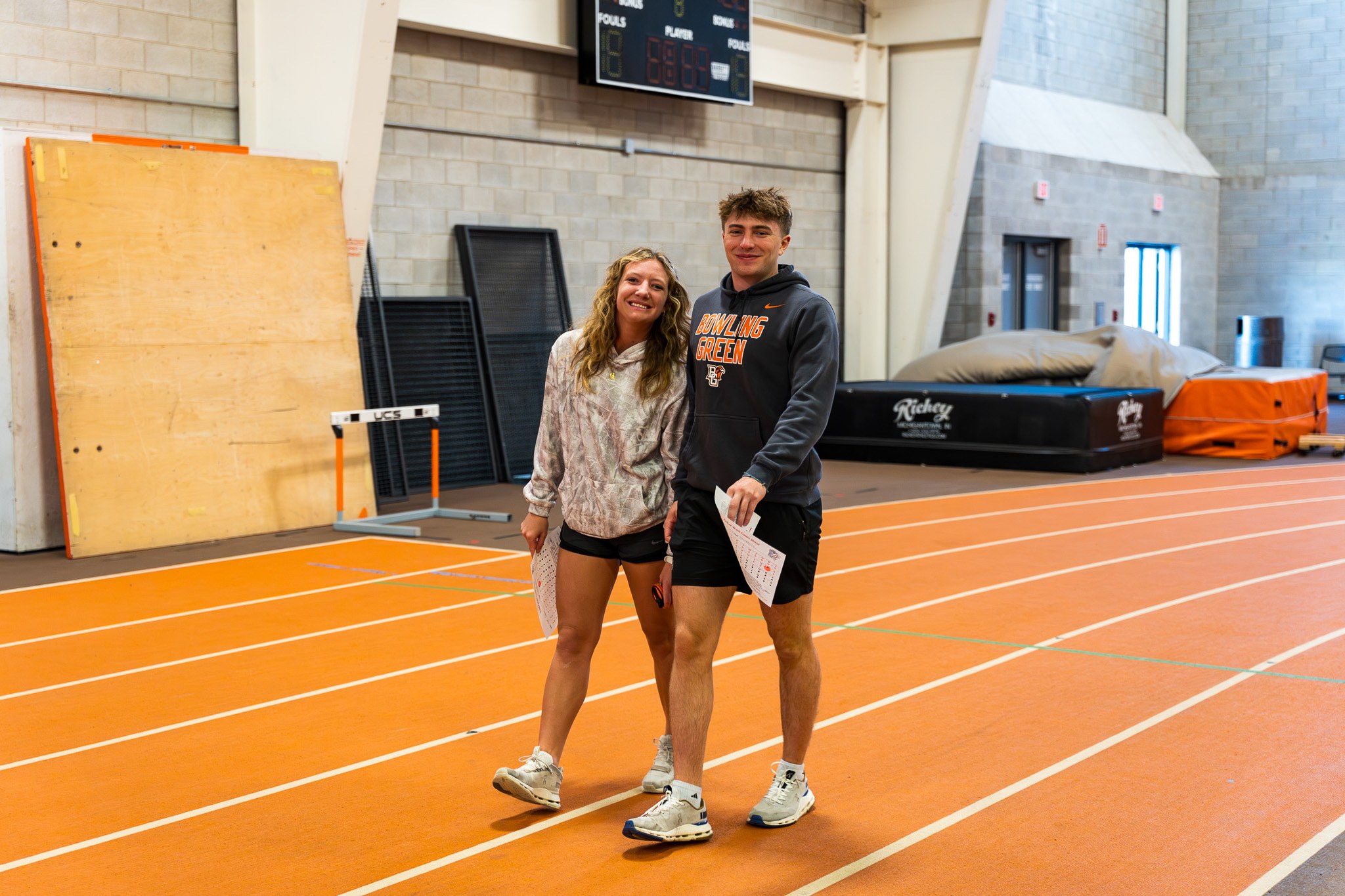 A male and a female walking closely together on the track during a past Well-O-Ween event