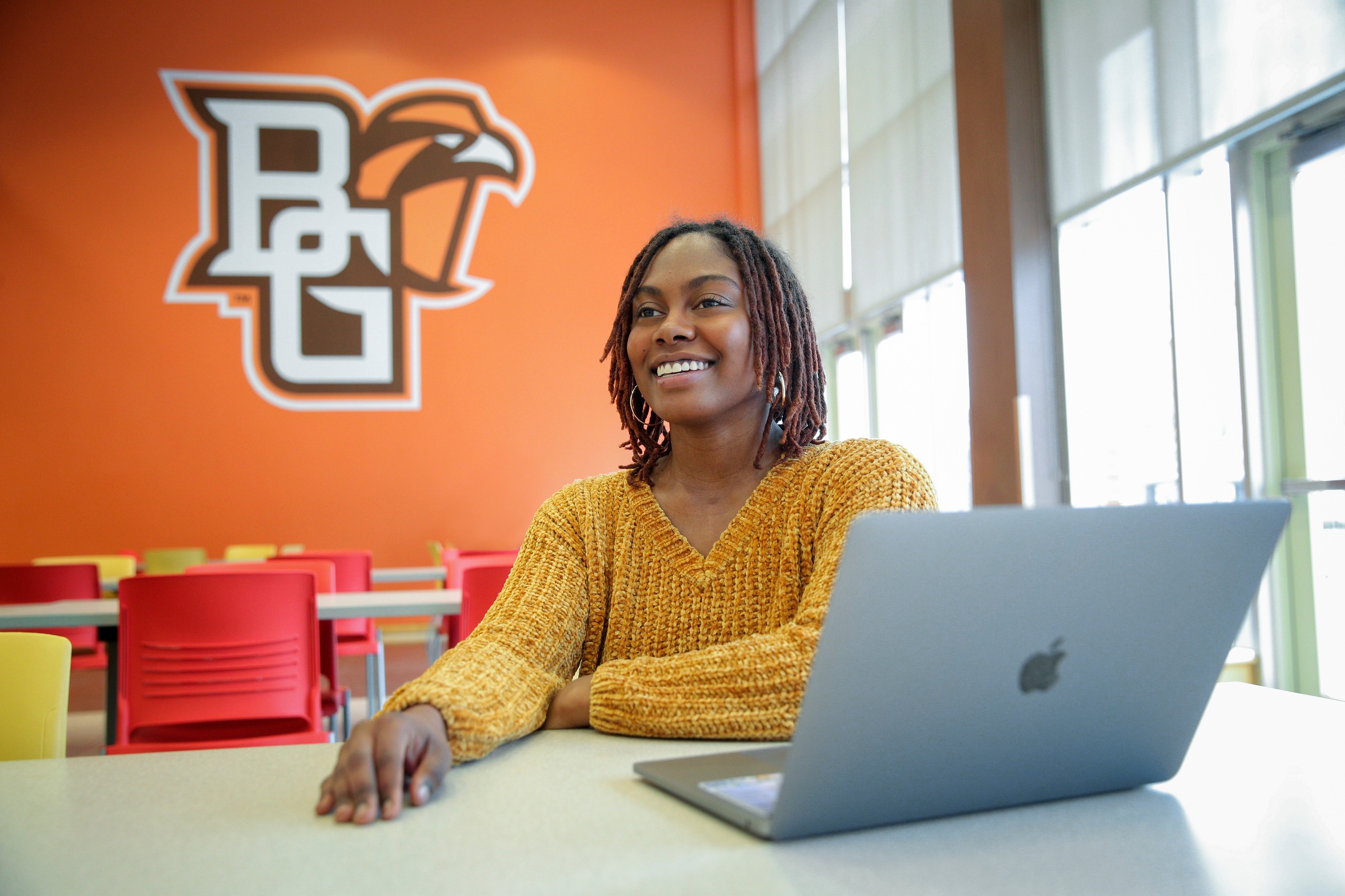 BGSU student smiling with her laptop
