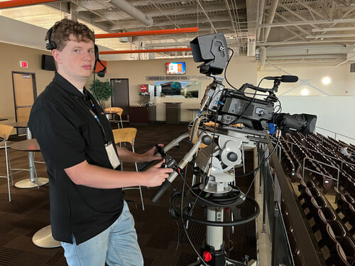 Jack Widenhofer is working the camera for the basketball game! 