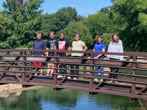 Clark Students on the bridge in the arboretum